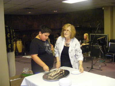 2010- Zaid is helped by Mary to cut the cake to mark finalizing of his 100 km walk1