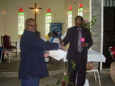 5 Dr Njenga giving charity to Church-Property aprox 0_25 acre1
